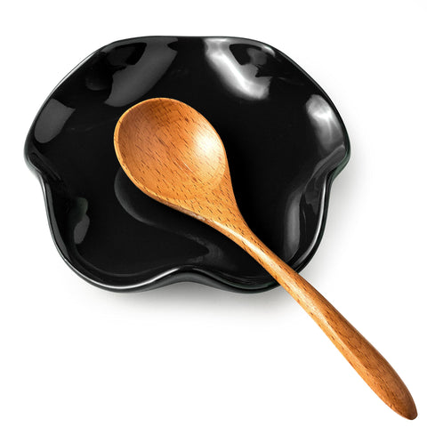 Miamolo spoon rest with flower-shaped ceramic design holds utensils neatly on the counter.
