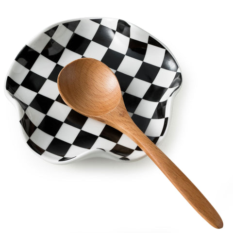 Miamolo spoon rest on stove top with checkered pattern keeps counters tidy.
