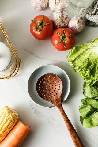 Miamolo spoon rest with drip tray catches spills for tidy countertops.