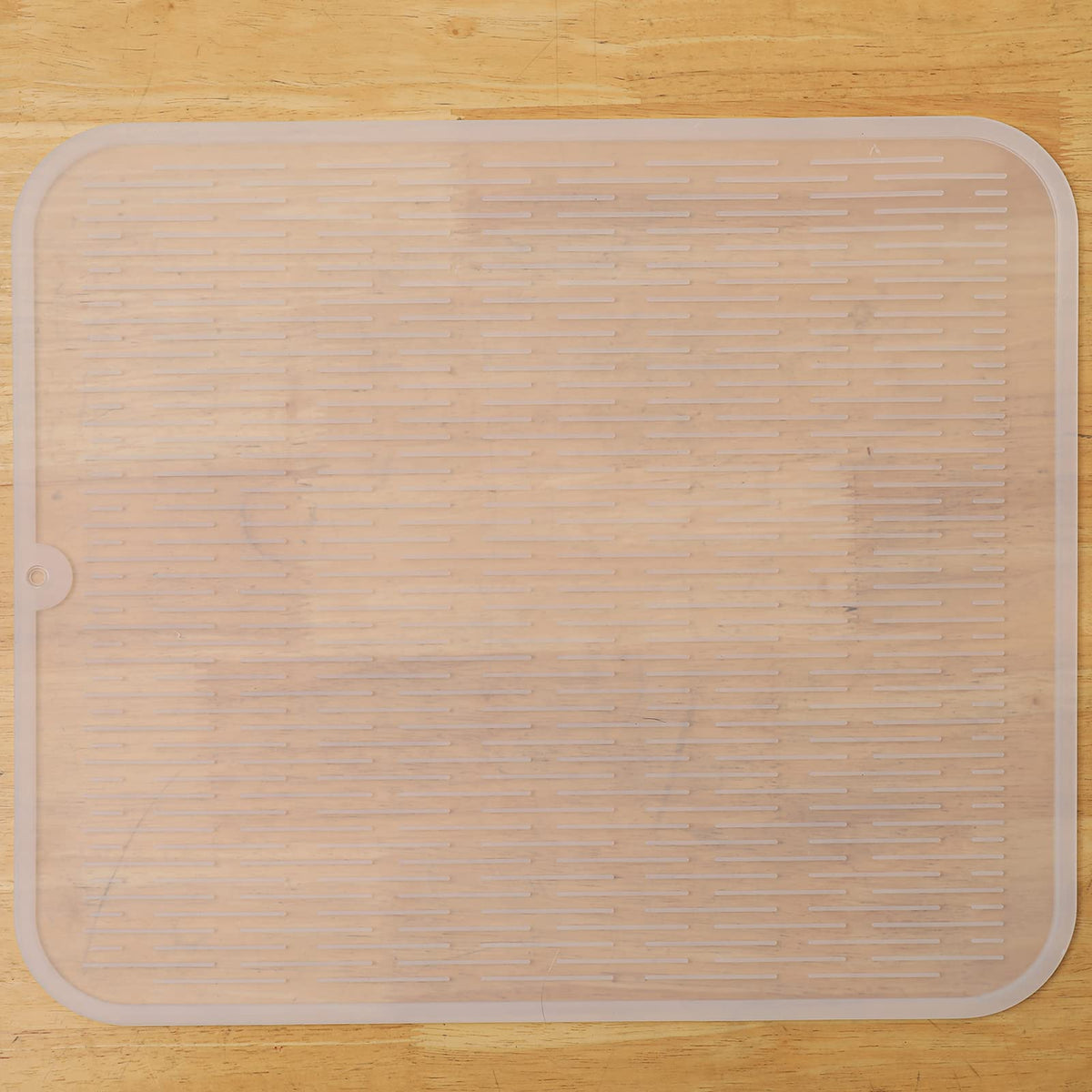 MicoYang silicone dish drying mat on a kitchen counter, providing a drying surface and surface protection.