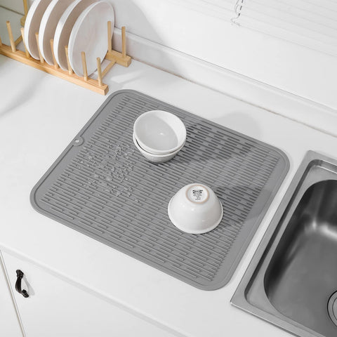 MicoYang silicone mat being rinsed under running water for easy cleaning