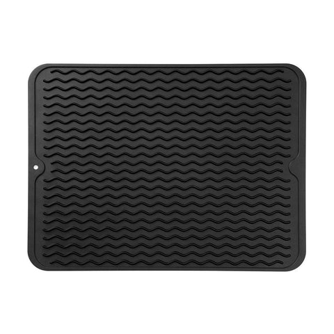MicoYang silicone drying mat on a kitchen counter, protecting surfaces while air-drying dishes.