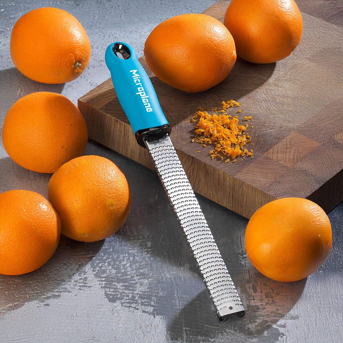 Microplane Premium Classic Turquoise in-use grater demonstrates easy zesting and grating.