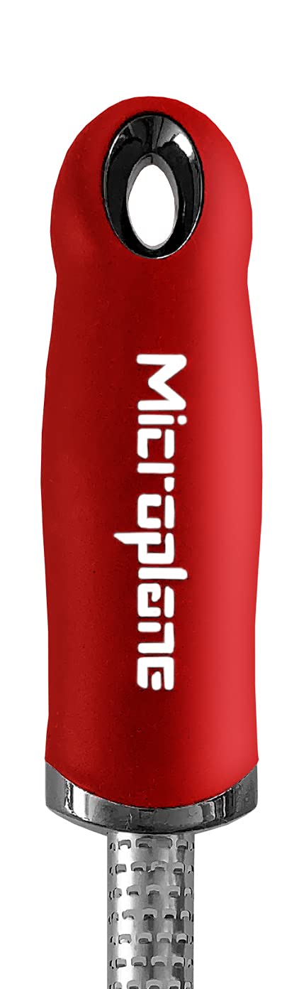 Microplane red spice grater creates aromatic cinnamon shavings for desserts.