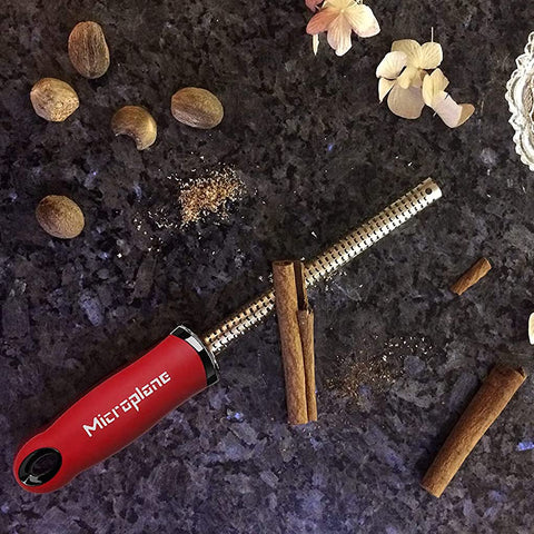 Red Microplane spice grater with safety cover for safe storage.