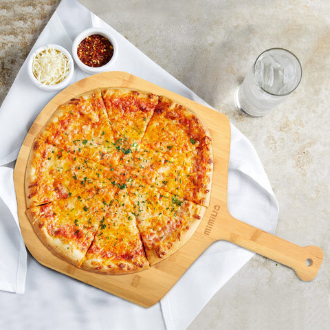 Mimiuo bamboo pizza peel sits beautifully as natural kitchen decor.