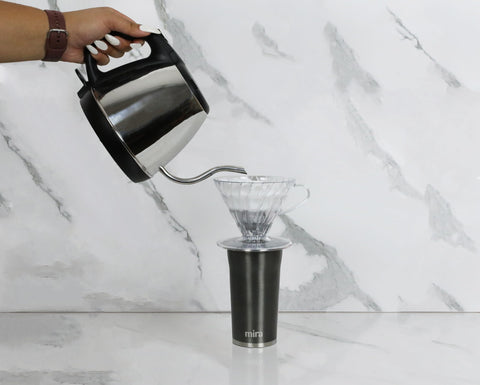 MIRA mug seated in a car cup holder for easy commuting.