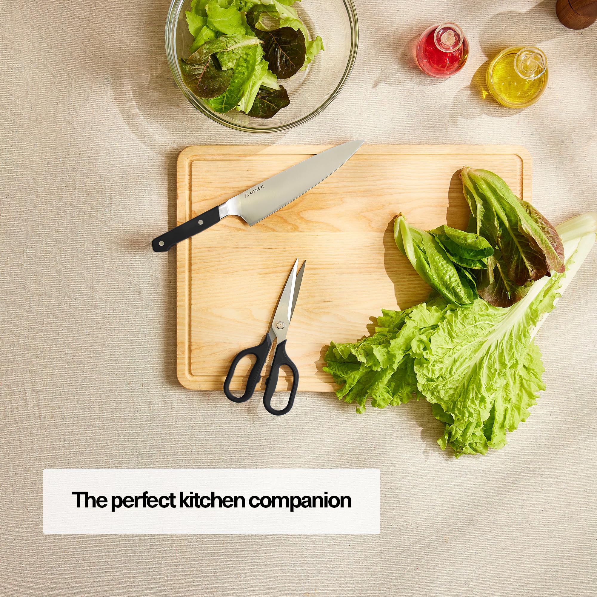 Misen heavy-duty kitchen shears cutting herbs for fresh, efficient prep.