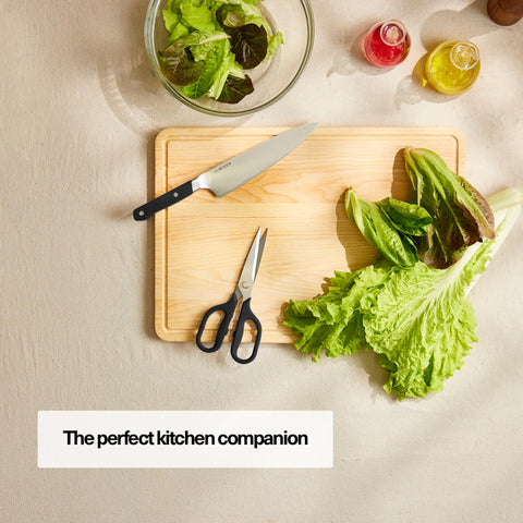 Misen heavy-duty kitchen shears cutting herbs for fresh, efficient prep.