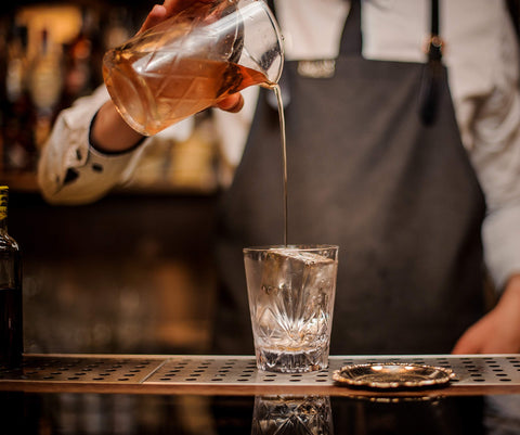Mixologists mixing glass with standard width compatible with common strainers.