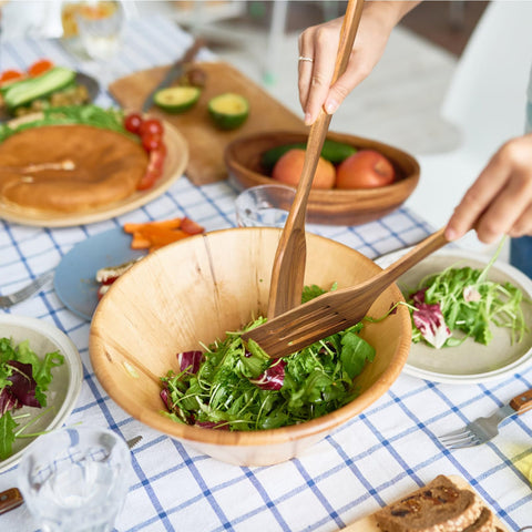 Mooues wooden utensils with holes in handles for easy hanging.