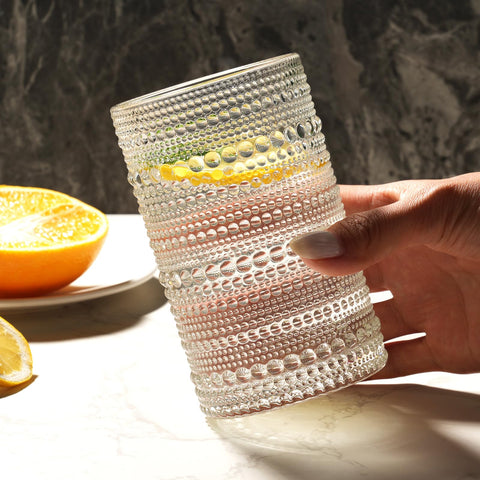 Moretoes clear glass tumbler suitable for whiskey, juice, beer, or soda.
