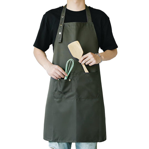 MORNITE apron in sage green with pockets keeps brushes organized for art and cooking.