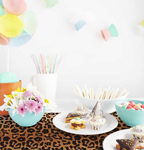 Disposable leopard table runner enabling quick cleanup after celebration.