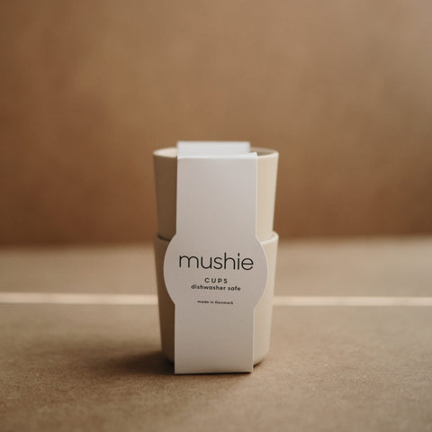 Mushie ivory cups for kids, child holding the cup to show grip.