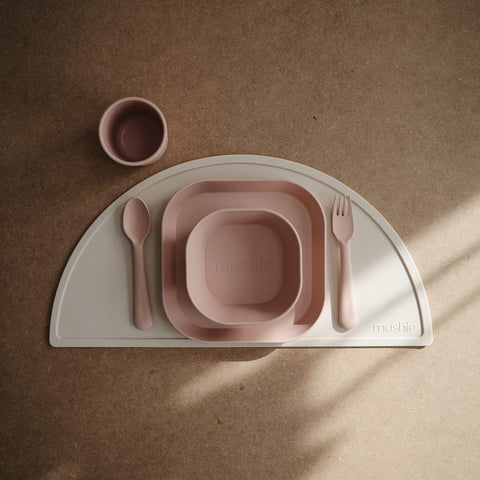Two Mushie blush plates stacked together, compact storage for small kitchens.