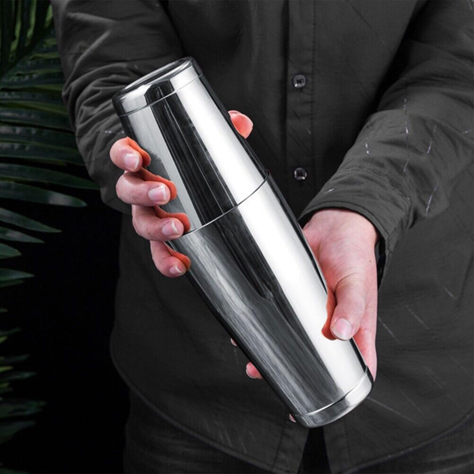 mwellewm shaker in hand pouring a drink for guests