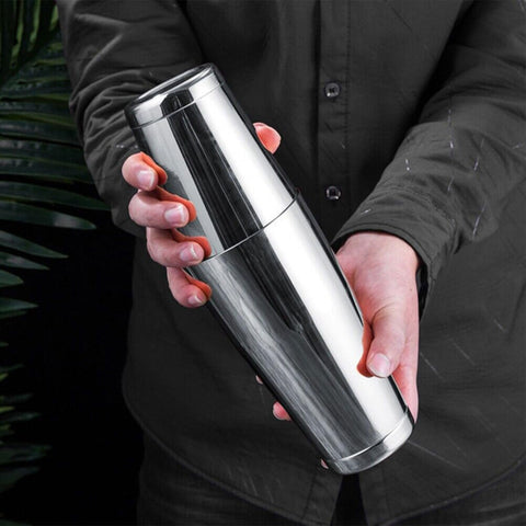 mwellewm shaker in hand pouring a drink for guests