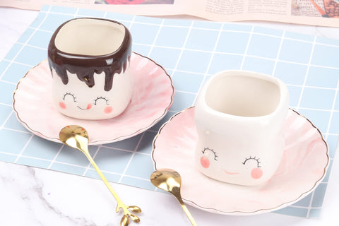 Mugs on table with hot chocolate, showcasing 6 oz capacity and charm.