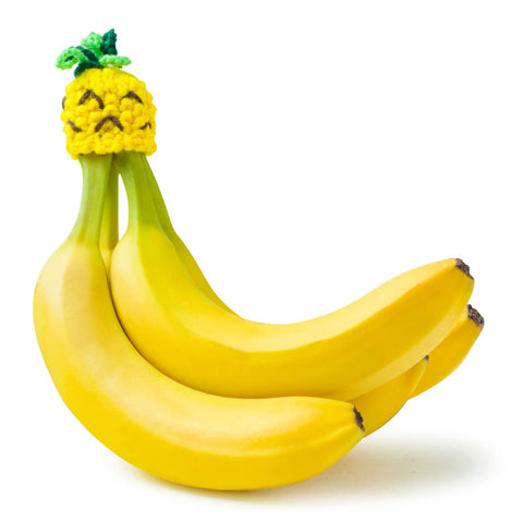 NANA HATS banana holder on counter organizes fruit while enabling quick, convenient access.