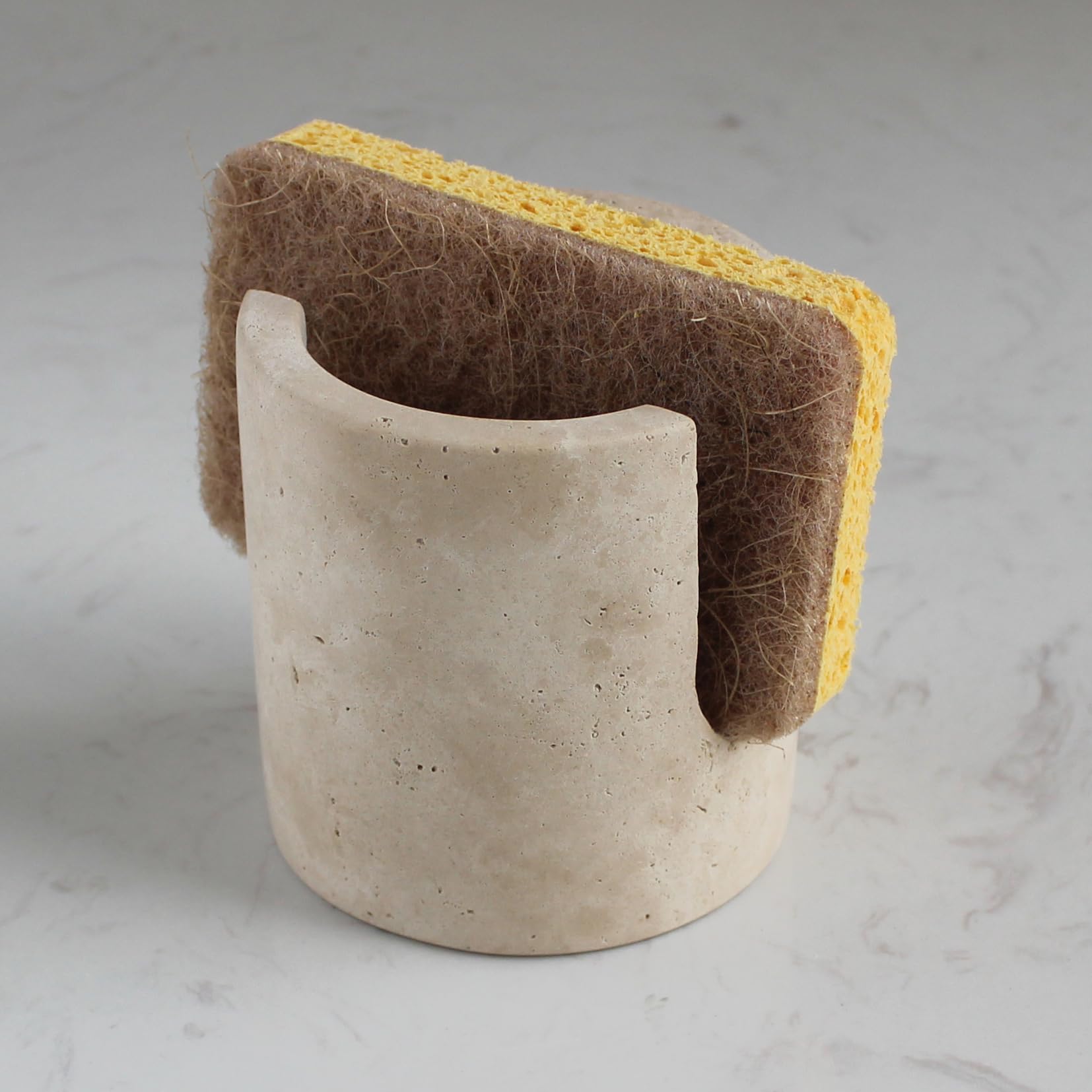 Nawgnail sponge holder in beige travertine showing quick-dry surface for a clean sink area