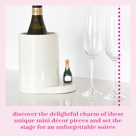 Nora Fleming hand-painted mini champagne bottle enhances table settings and displays.