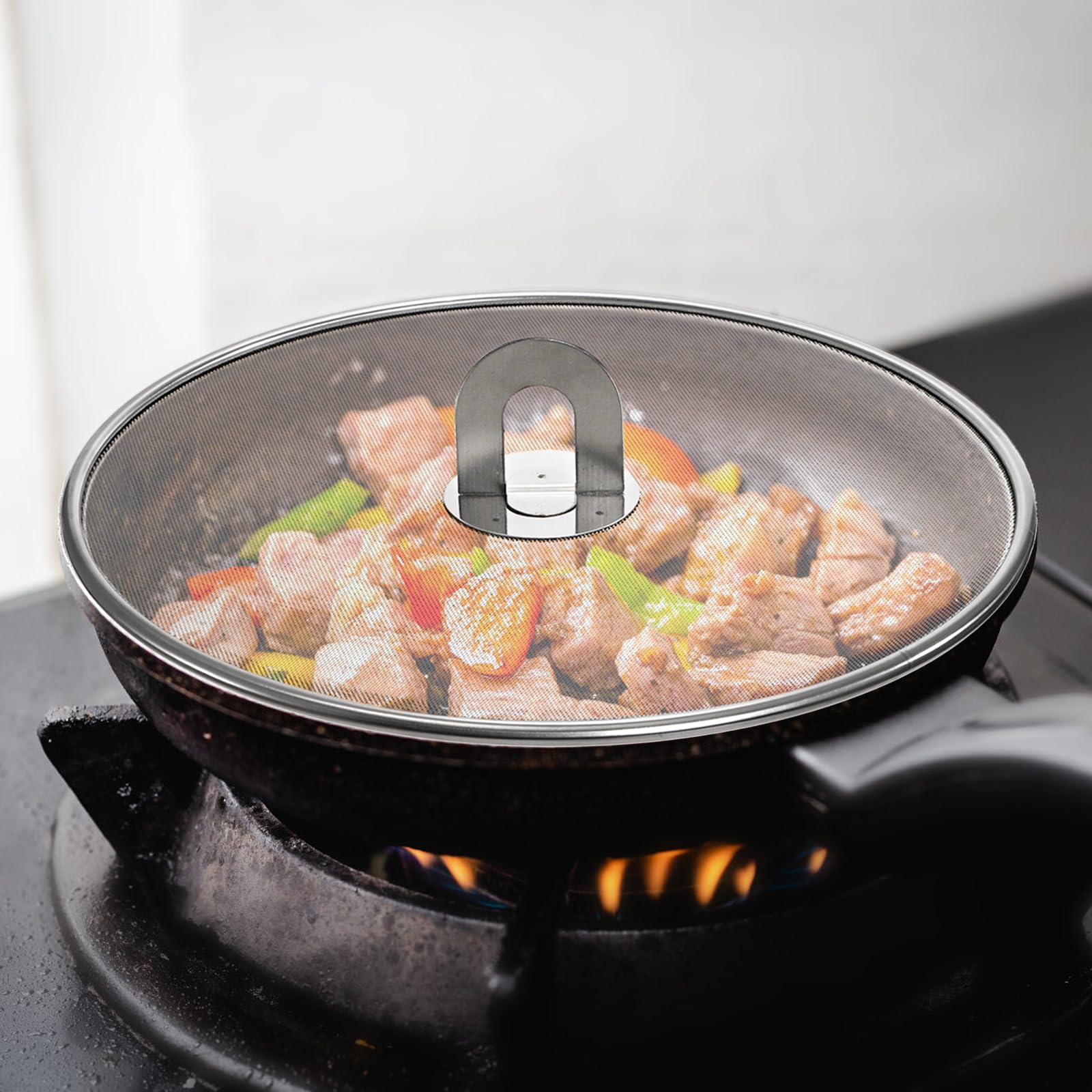 Nicunom 13-inch splatter screen covers a large pan for neat frying.