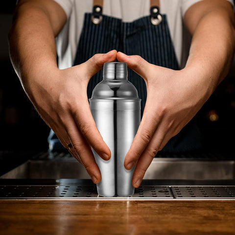 Nitial bar setup with shaker showcases versatile cocktail-making in any setting
