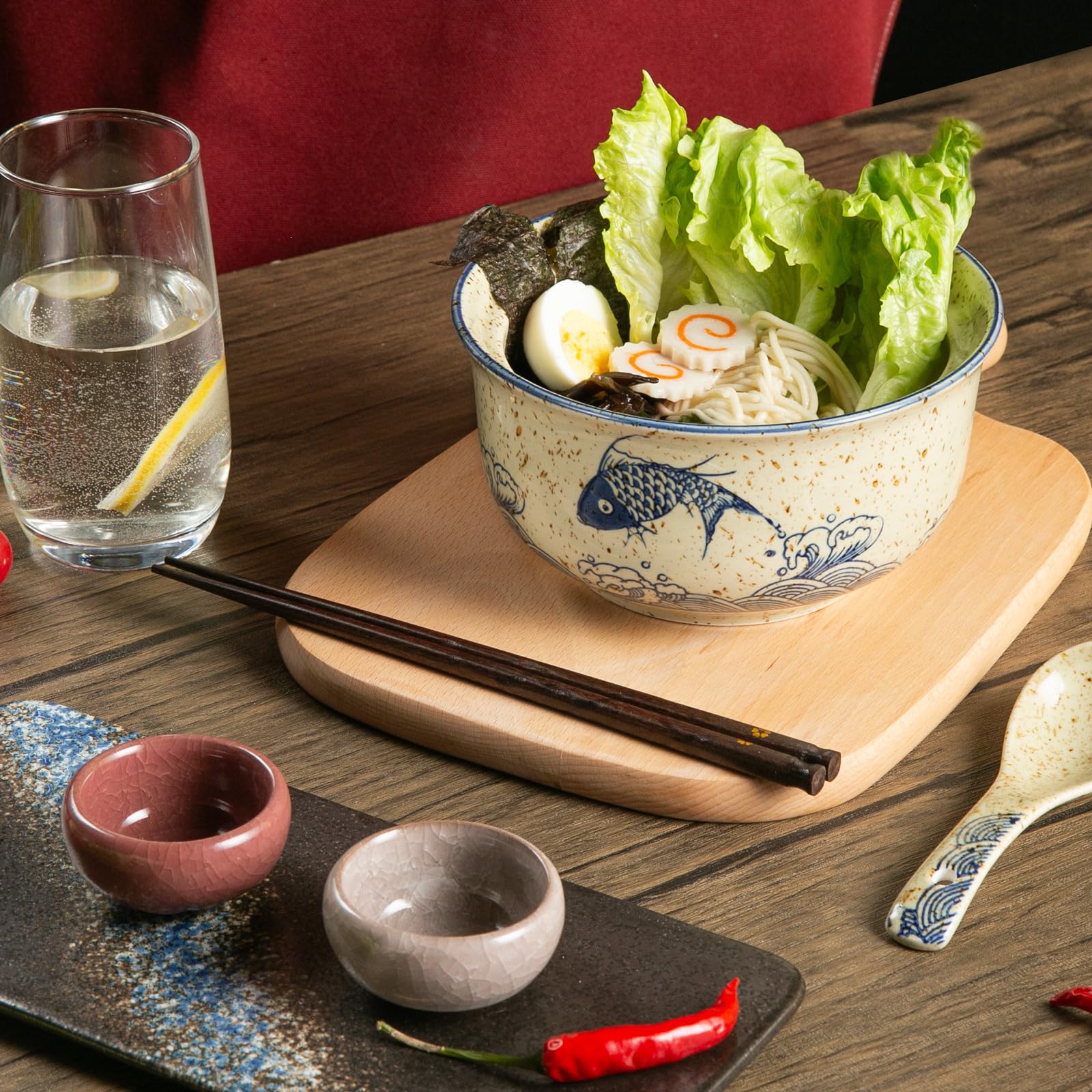 Niturceal spoons and chopsticks accompany bowls for a complete setting.