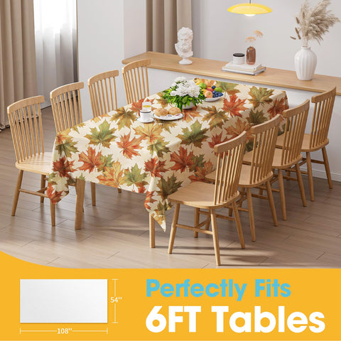 Table setting with autumn decor highlighting maple themed table cover.