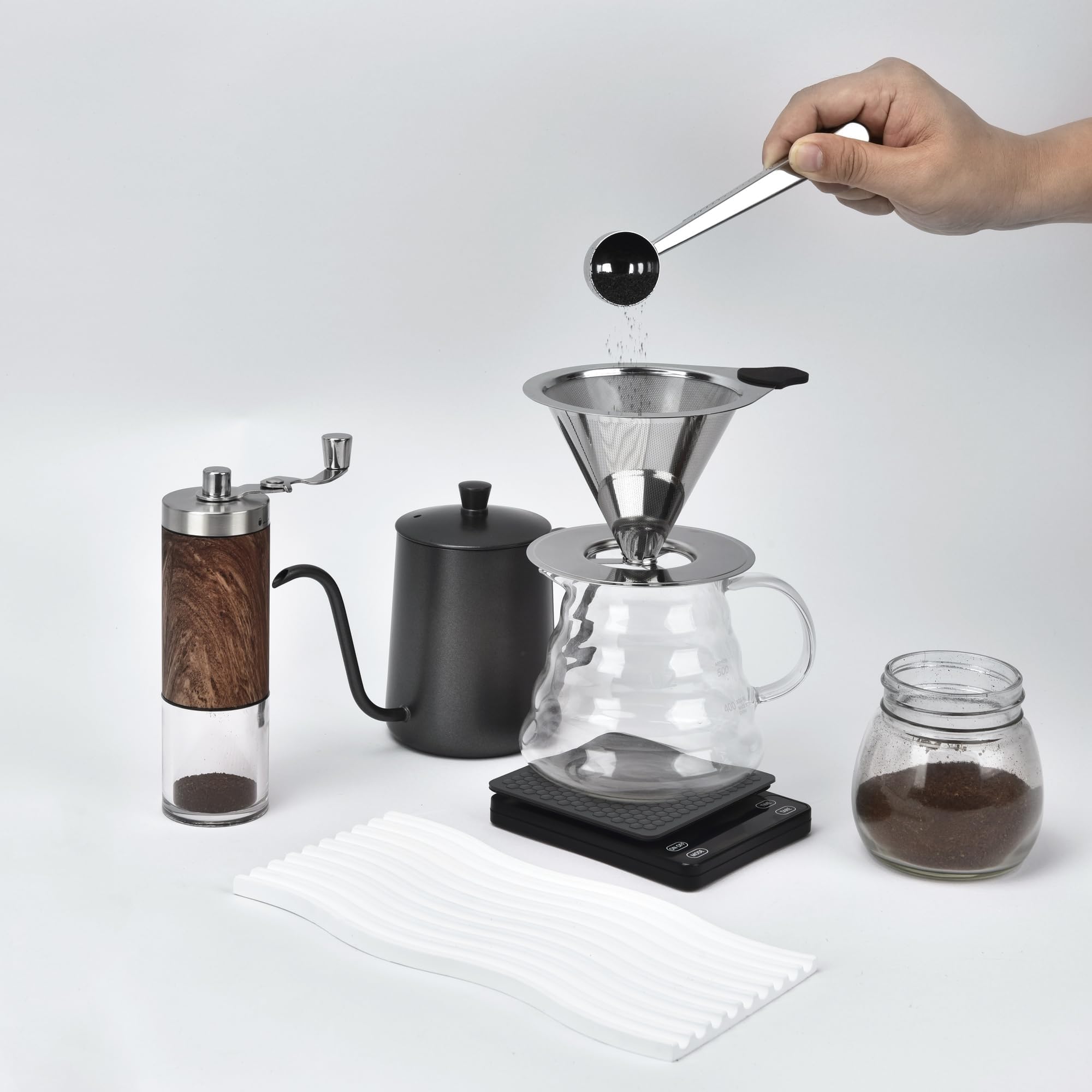 Nkove portable kit with brush for on-the-go coffee brewing.