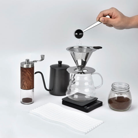 Nkove portable kit with brush for on-the-go coffee brewing.