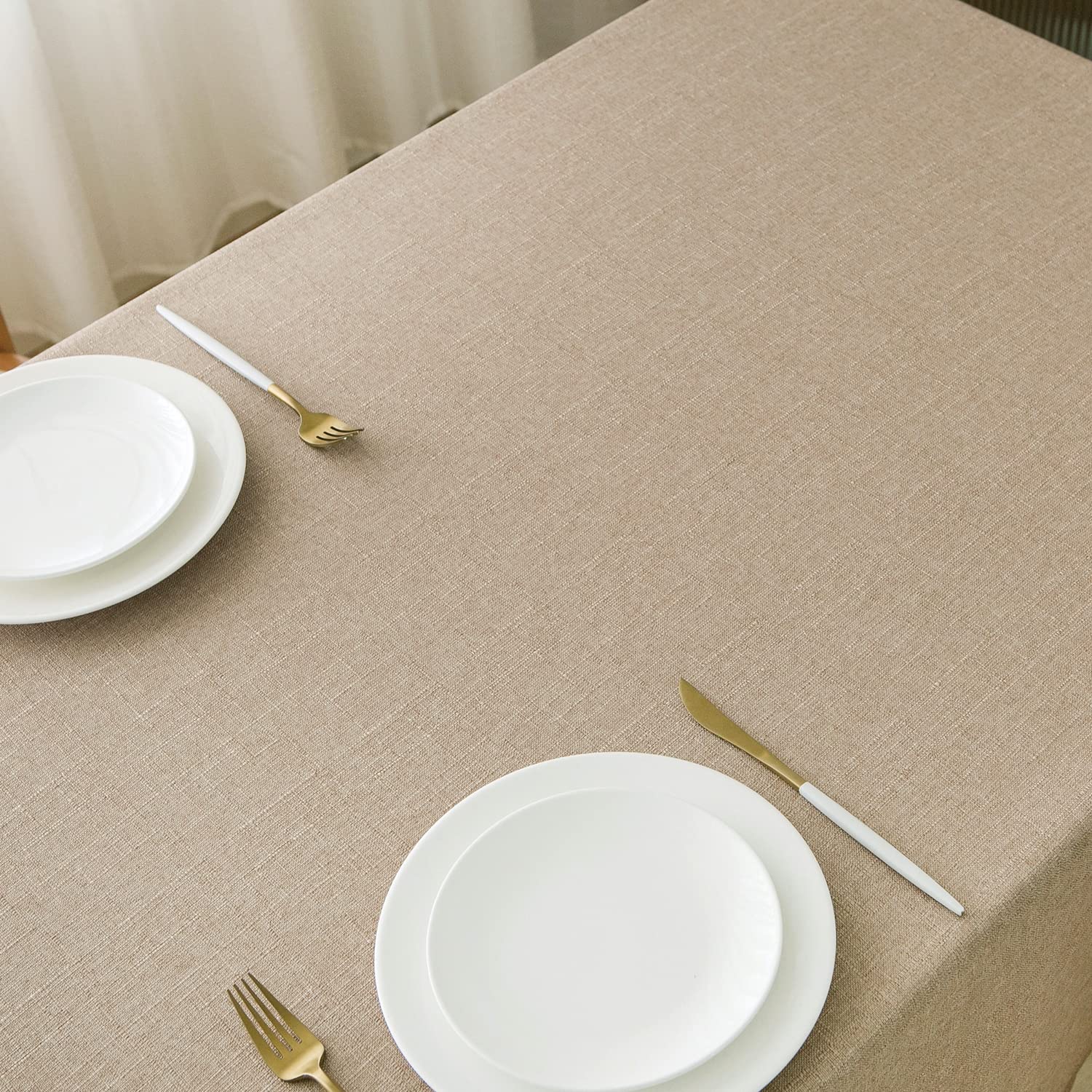 NLMUVW tan linen table cloth showing spill protection on a surface.