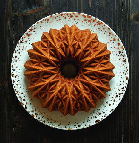 Nordic Ware Cut Crystal Bundt 10-Cup Gold swirl-detail close-up showcases sculptural ridges.