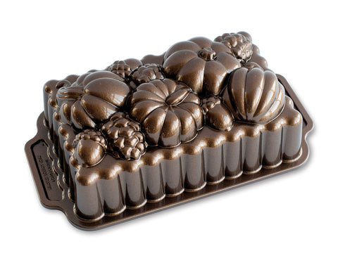 Nordic Ware Harvest Bounty Loaf Pan side view highlights durable cast aluminum for even browning.