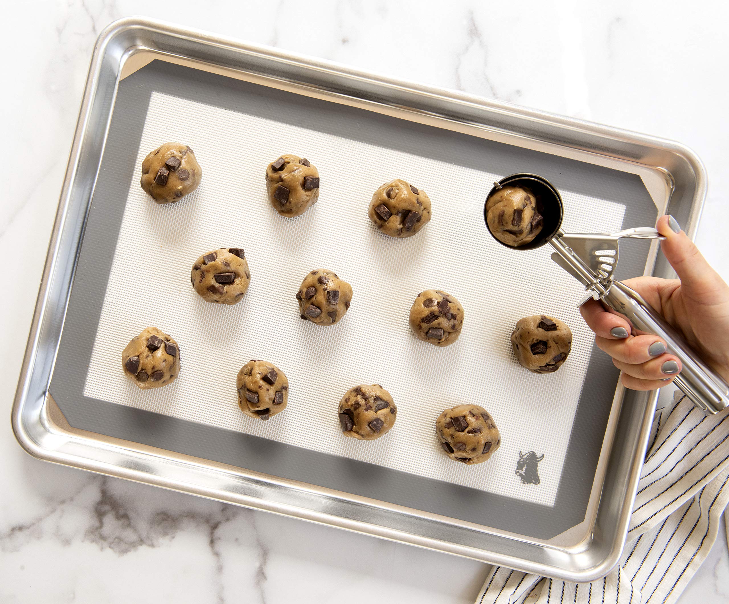 Nordic Ware cookie scoop shown for easy maintenance with hand wash recommended.