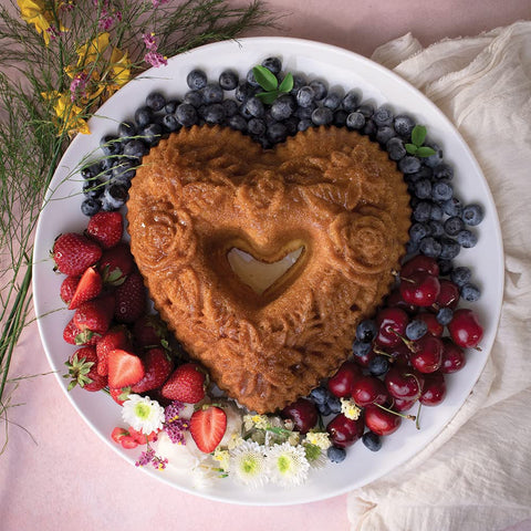 Nordic Ware Wildflower Heart Bundt pan in hand demonstrates easy release thanks to silicone.