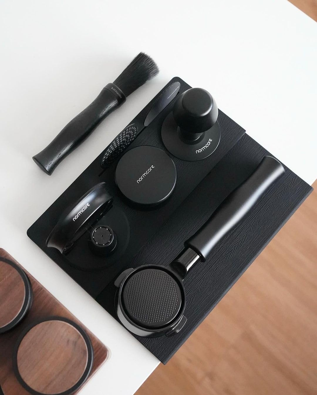 Normcore portafilter holder secures 51–58 mm setups during tamping