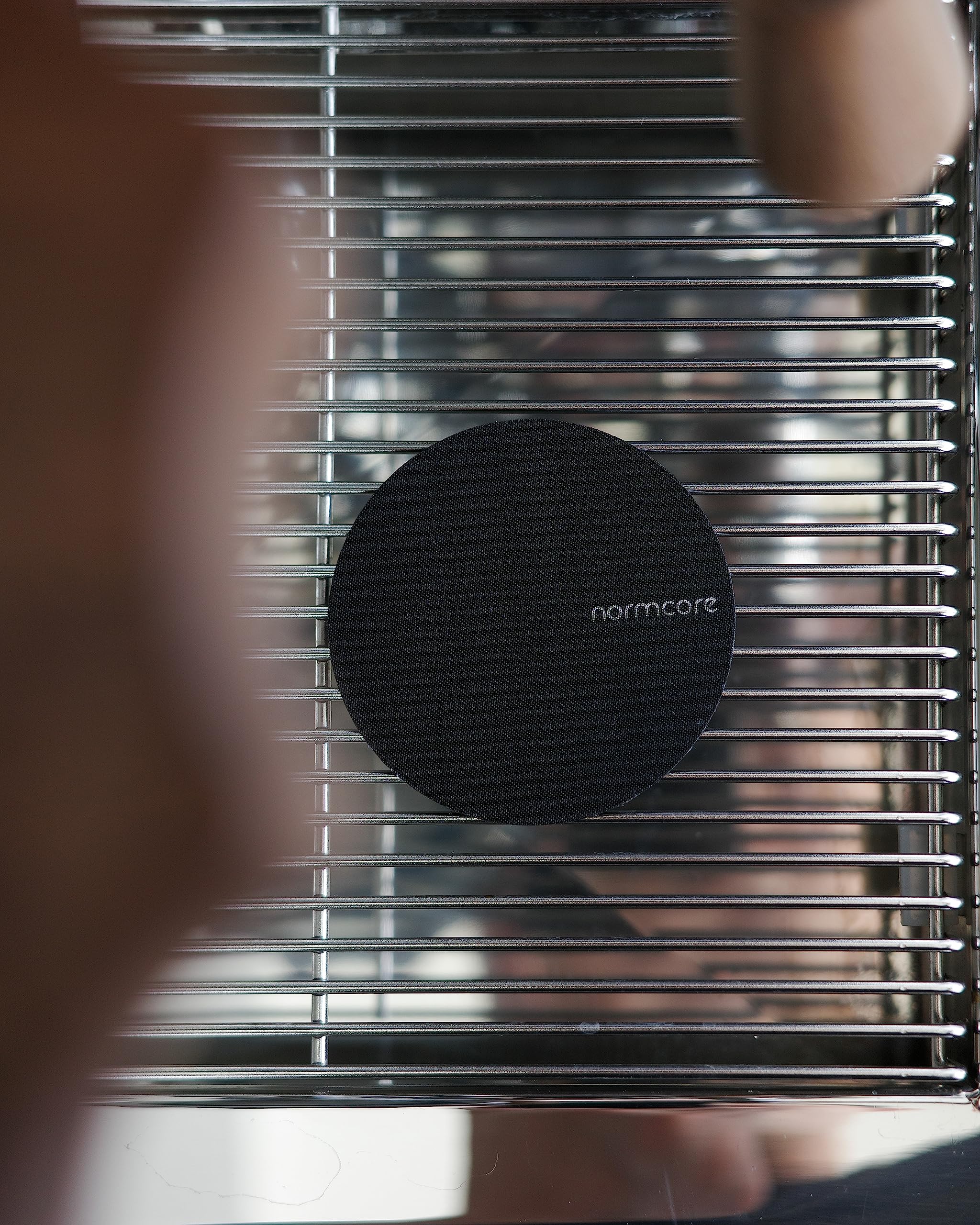 Normcore puck screen close-up showing titanium PVD coating for corrosion resistance.