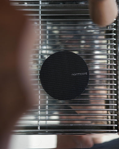 Normcore puck screen close-up showing titanium PVD coating for corrosion resistance.