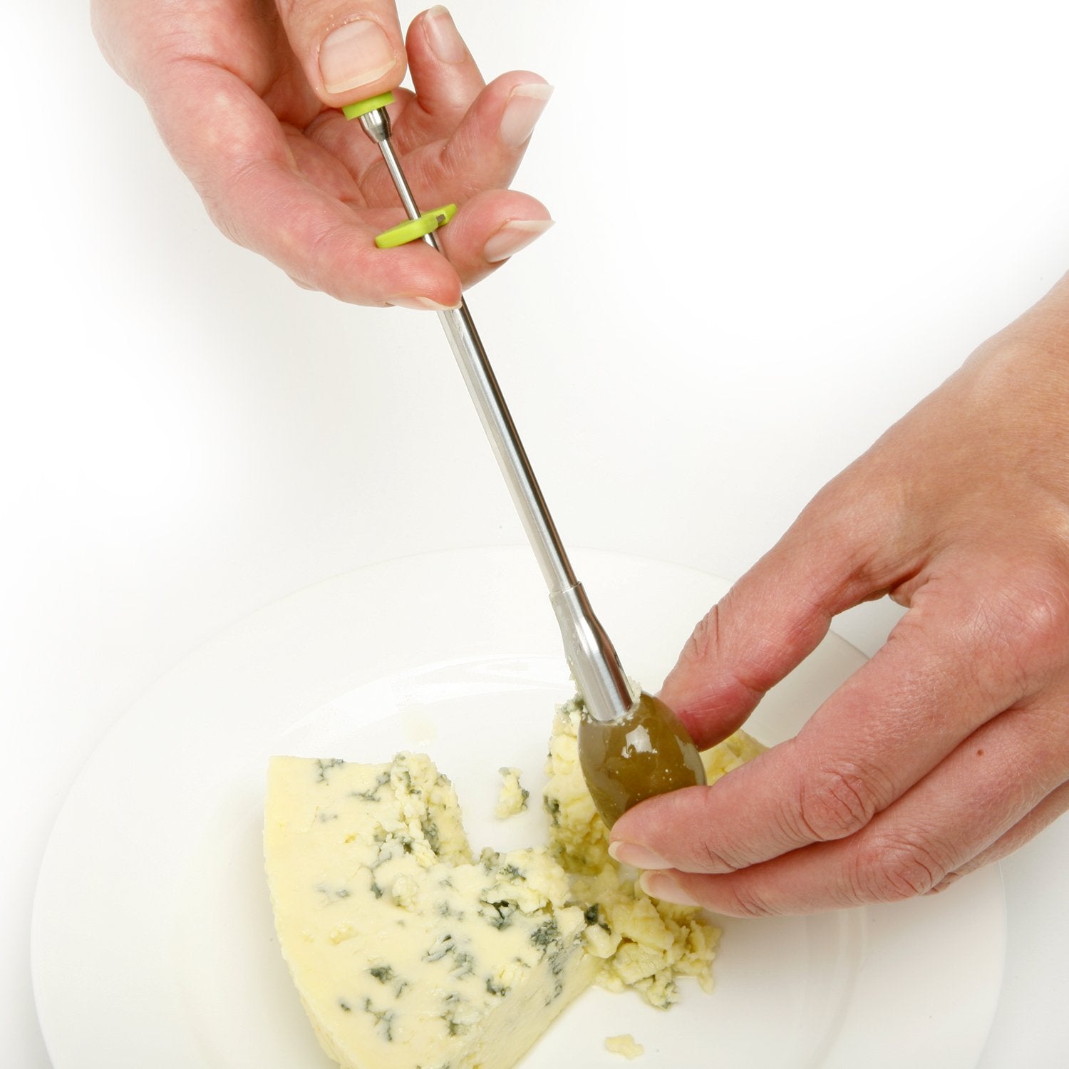 Norpro stainless steel olive stuffer injecting cheese into olives for cocktails.