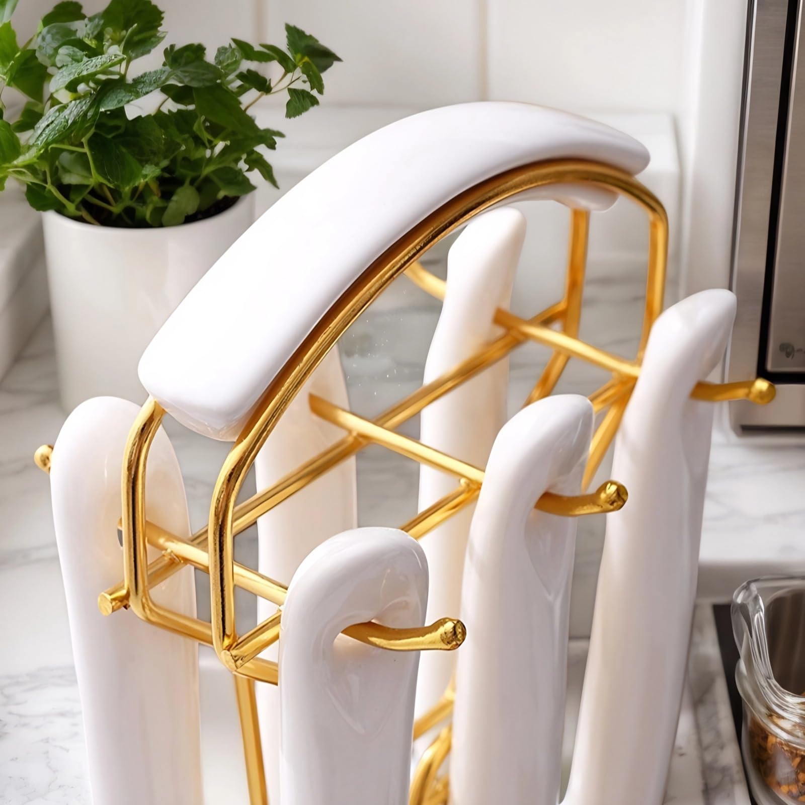 Novellus utensil holder in white and gold keeps tools organized on the counter.