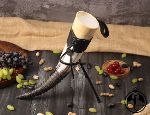OLDEMPEROR horn with artistic carvings and a polished finish.