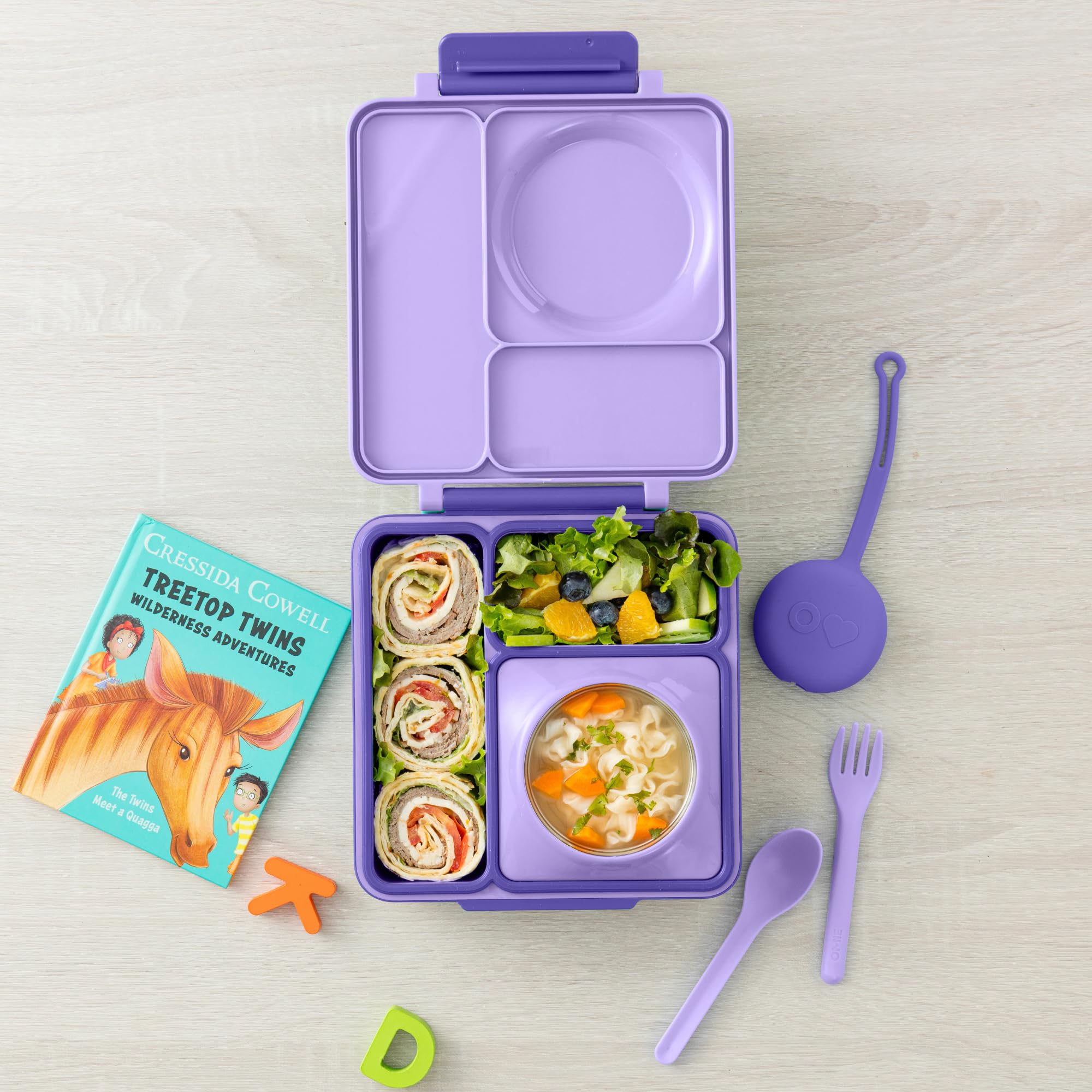 OmieBox spoon and fork inside pod for mess-free meals.