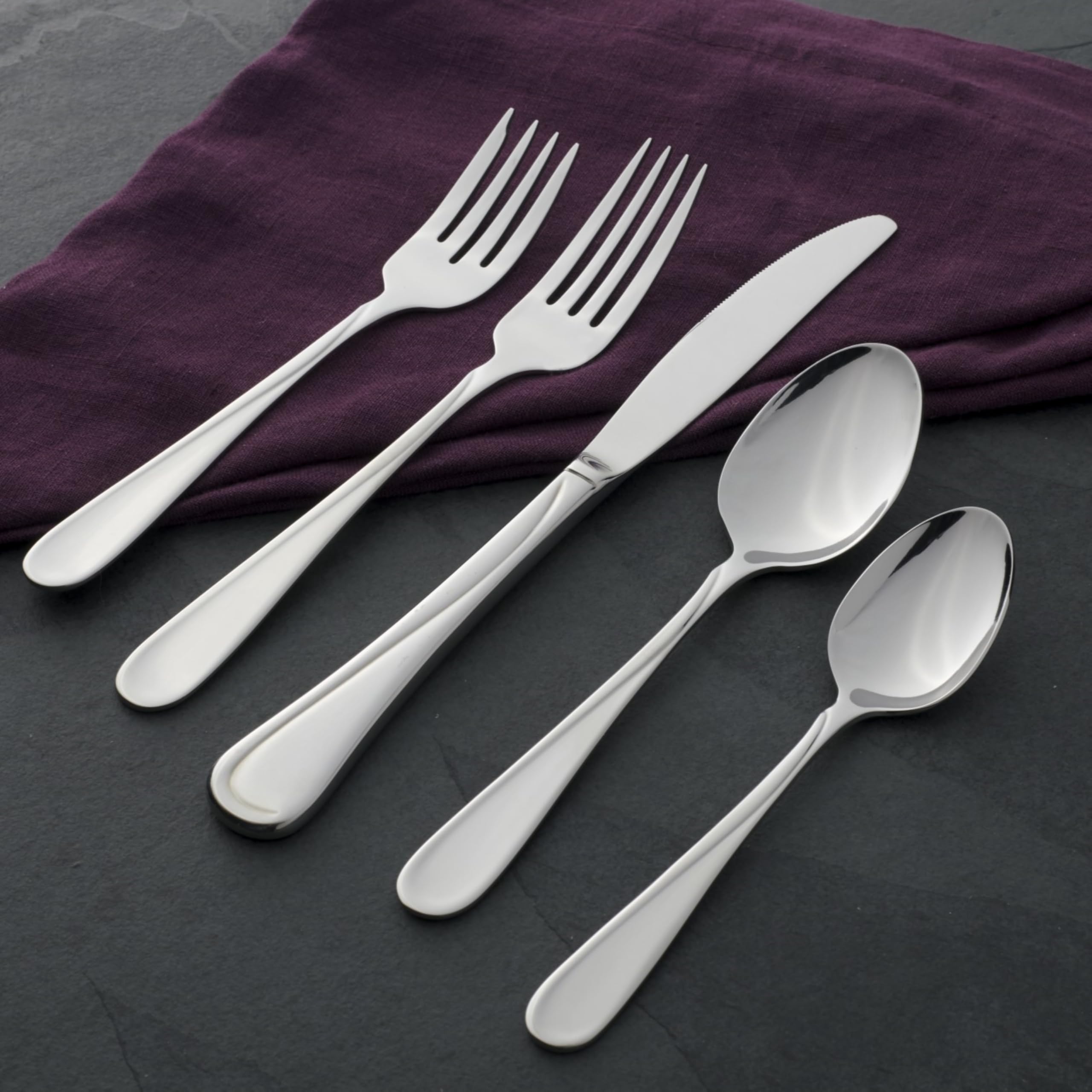 Oneida Flight spoon set on a dining table to illustrate balanced design