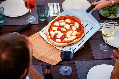 Ooni perforated dough-transfer peel reduces mess while cooking.