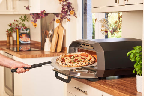 Ooni flour-dusting tip helps release dough with minimal sticking.