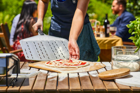 Ooni perforated pizza peel aluminum finish offers lightweight handling.
