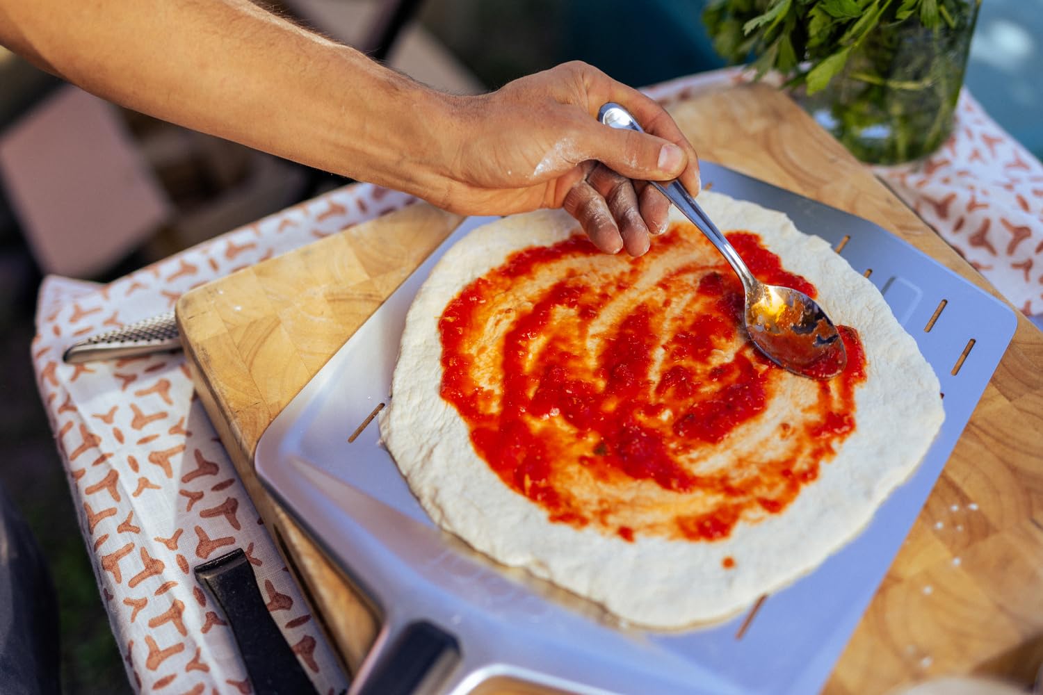 Ooni perforated pizza peel aluminum lightweight and durable for quick turnover.