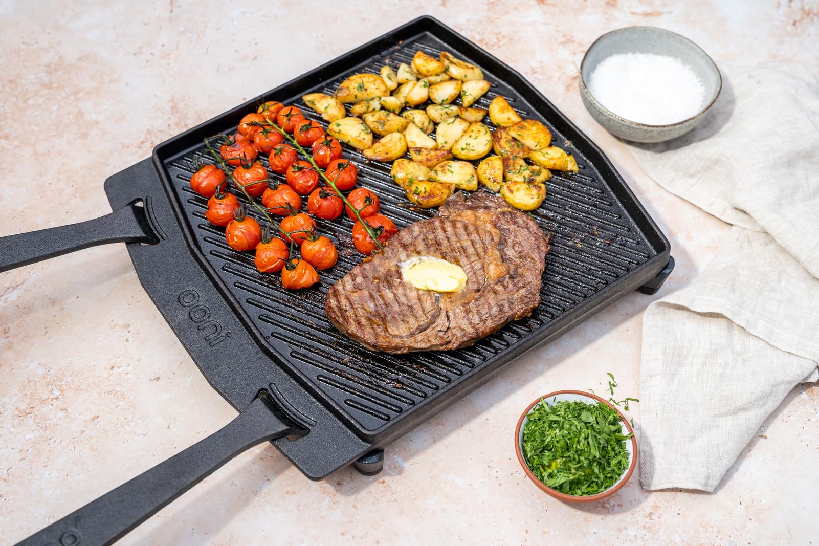 Ooni plate for open-fire cooking and outdoor use.